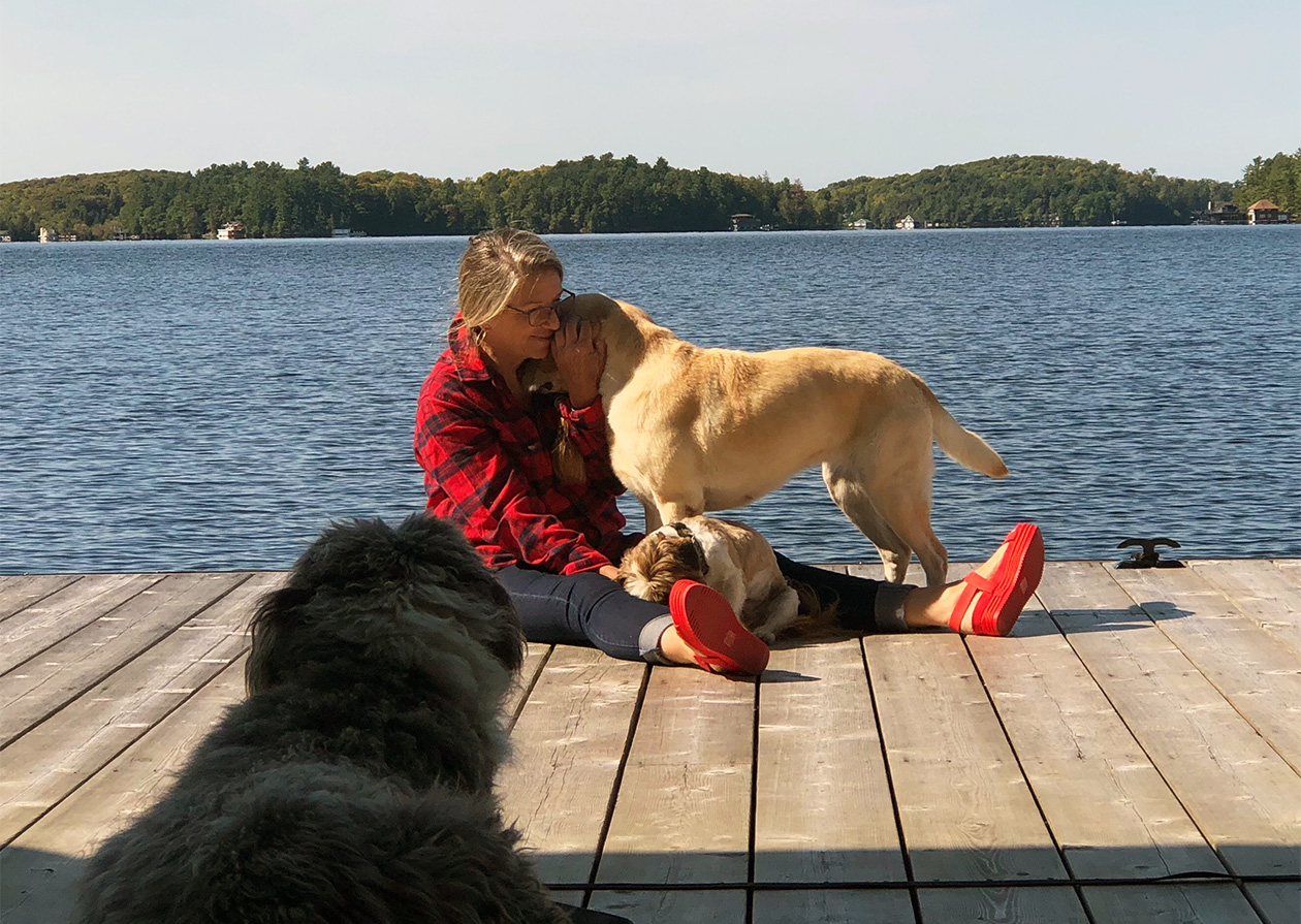 Val with her dogs on the dock